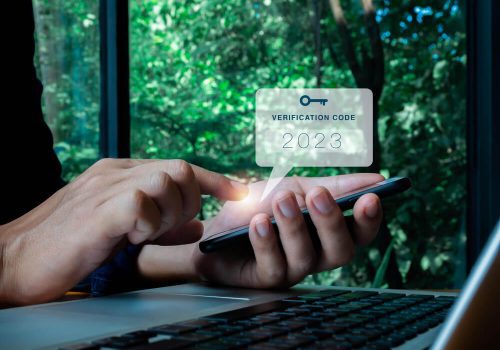 two-steps-authentication-2fa-concept-2023-verification-code-with-key-icon-smart-phone-screen-hand-with-laptop-validate-password-page-identity-verification-cyber-security-technology (1)